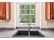 The kitchen features a stainless steel faucet and a double basin sink with a large window view at 8640 Amsbury Way, Cumming, GA 30041