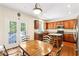 Charming eat-in kitchen featuring wood cabinetry, stainless steel appliances and a walkout to deck at 8640 Amsbury Way, Cumming, GA 30041