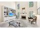 Inviting living room featuring a built-in entertainment center and fireplace with natural light at 8640 Amsbury Way, Cumming, GA 30041