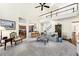 Spacious living room with open floor plan, fireplace, and access to the kitchen and staircase at 8640 Amsbury Way, Cumming, GA 30041