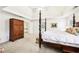 Bright primary bedroom with coffered ceiling, carpet, four-poster bed and closet access at 8640 Amsbury Way, Cumming, GA 30041