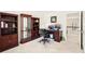 Spacious office area with multiple workspaces, shelving, and natural light from nearby windows at 8640 Amsbury Way, Cumming, GA 30041
