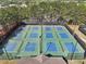 An aerial view shows multiple pickleball courts for outdoor recreational activities, surrounded by trees and landscaping at 8640 Amsbury Way, Cumming, GA 30041