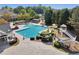 The aerial view displays the outdoor pool and spiral water slide that provide recreational opportunities at 8640 Amsbury Way, Cumming, GA 30041