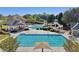 A refreshing swimming pool and a spiral water slide surrounded by lush greenery for Gathering enjoyment at 8640 Amsbury Way, Cumming, GA 30041