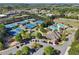 Aerial view of tennis courts and a pool surrounded by trees and a parking lot, indicating nearby amenities at 8640 Amsbury Way, Cumming, GA 30041