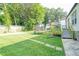 Large backyard with green lawn, deck, trampoline, and storage building at 98 Chappell Nw Rd, Atlanta, GA 30314