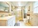 Well-lit bathroom features a large vanity and tiled shower with glass door at 98 Chappell Nw Rd, Atlanta, GA 30314