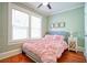 Bedroom with hardwood floors, natural light, and a bed with pink bedding at 98 Chappell Nw Rd, Atlanta, GA 30314