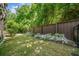 Green backyard featuring a privacy fence, grassy area, and garden with beautiful white flowers at 2166 Sonoma Se Dr, Smyrna, GA 30080