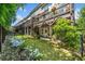 Beautiful backyard of townhomes featuring a green lawn, stone landscaping, and wooden patios for each unit at 2166 Sonoma Se Dr, Smyrna, GA 30080