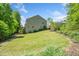 Green backyard with mature trees surrounding the property and providing privacy at 2166 Sonoma Se Dr, Smyrna, GA 30080