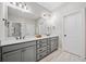 Bathroom with a double sink vanity, a large mirror, and stylish lighting at 2166 Sonoma Se Dr, Smyrna, GA 30080
