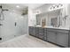 Modern bathroom with gray cabinets, double sinks, and glass-enclosed shower at 2166 Sonoma Se Dr, Smyrna, GA 30080