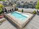 Aerial view featuring a community pool, surrounding townhomes, parking spaces, and landscaping at 2166 Sonoma Se Dr, Smyrna, GA 30080