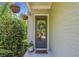 Charming front door with decorative wreath, potted plants, and hanging baskets creates a welcoming entrance at 2166 Sonoma Se Dr, Smyrna, GA 30080