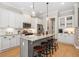 Bright kitchen featuring white cabinetry, granite counters and a central island with barstool seating at 2166 Sonoma Se Dr, Smyrna, GA 30080