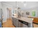 Bright kitchen with an island, stainless steel appliances, and a staircase leading to the upper level at 2166 Sonoma Se Dr, Smyrna, GA 30080