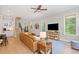 Open living room with natural light, wood floors, and a staircase leading to the upper level at 2166 Sonoma Se Dr, Smyrna, GA 30080