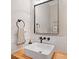 Modern powder room featuring a square sink, black hardware and a framed mirror at 2166 Sonoma Se Dr, Smyrna, GA 30080