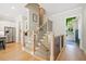 Inviting staircase with wooden railings, iron balusters, and hardwood floors, seamlessly connecting the home's levels at 2166 Sonoma Se Dr, Smyrna, GA 30080