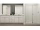 Modern bathroom with double vanity, large mirrors, and a glass-enclosed shower at 2429 Livi Ln, Buford, GA 30519