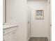 A bright bathroom featuring a shower with glass door, white vanity, and stylish decor at 2429 Livi Ln, Buford, GA 30519