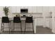 Modern kitchen with an island, stylish barstools, stainless steel appliances, and white cabinets at 2429 Livi Ln, Buford, GA 30519