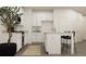 Modern kitchen with white cabinetry, stainless steel appliances, and a cozy island at 2429 Livi Ln, Buford, GA 30519
