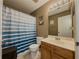 Traditional bathroom showcasing a striped shower curtain, wooden vanity, and a neutral color scheme at 2775 Storybook Ct, Grayson, GA 30017