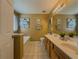 Bright bathroom featuring double sinks, wood cabinets, and a clean, tiled floor at 2775 Storybook Ct, Grayson, GA 30017