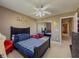 Charming bedroom with a ceiling fan, playful wall stickers, and red and blue decor at 2775 Storybook Ct, Grayson, GA 30017