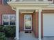 Close-up of the home's entrance, featuring a brick facade and covered porch at 2775 Storybook Ct, Grayson, GA 30017