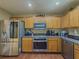 Well-equipped kitchen with stainless steel appliances and wood cabinetry at 2775 Storybook Ct, Grayson, GA 30017
