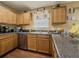 Functional kitchen space with wood cabinets and granite-style countertops at 2775 Storybook Ct, Grayson, GA 30017