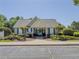 Exterior view of the community pool house with lush landscaping and ample parking at 2775 Storybook Ct, Grayson, GA 30017