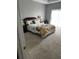 Bedroom featuring a queen-size bed with patterned bedding and a bedside table at 280 Ridge Bluff Ln, Suwanee, GA 30024