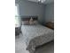 Cozy bedroom featuring a queen bed with unique animal print bedding and a wicker headboard at 280 Ridge Bluff Ln, Suwanee, GA 30024