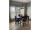 Cozy dining room featuring a dark wood table, chairs, and natural light at 280 Ridge Bluff Ln, Suwanee, GA 30024