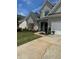 Charming gray two-story home with manicured landscaping and long driveway at 280 Ridge Bluff Ln, Suwanee, GA 30024