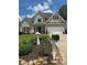 Charming gray two-story home with manicured landscaping and stone accents at 280 Ridge Bluff Ln, Suwanee, GA 30024