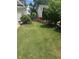 Spacious backyard with lush lawn and landscaped flower beds at 280 Ridge Bluff Ln, Suwanee, GA 30024