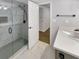 Bathroom featuring a glass shower, white marble floors, and a vanity with white countertops at 4254 River Green Nw Dr # 612, Atlanta, GA 30327