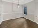 This dining room features hardwood floors, a pendant light, a large window, and white trim at 4254 River Green Nw Dr # 612, Atlanta, GA 30327