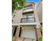 Townhome exterior featuring a front-entry garage, brick columns and private balconies at 4254 River Green Nw Dr # 612, Atlanta, GA 30327