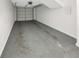 Garage features a gray concrete floor and a white painted wall with a roll up door at 4254 River Green Nw Dr # 612, Atlanta, GA 30327