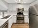 Modern kitchen featuring stainless steel appliances, white cabinetry, and ample counter space at 4254 River Green Nw Dr # 612, Atlanta, GA 30327