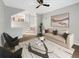 Bright living room features modern decor, a ceiling fan and an open floorplan leading to the kitchen at 4254 River Green Nw Dr # 612, Atlanta, GA 30327