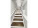 View of the staircase featuring wood treads and white risers with white rails at 4254 River Green Nw Dr # 612, Atlanta, GA 30327