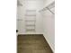 Walk-in closet featuring hardwood floors and metal shelving racks at 4254 River Green Nw Dr # 612, Atlanta, GA 30327